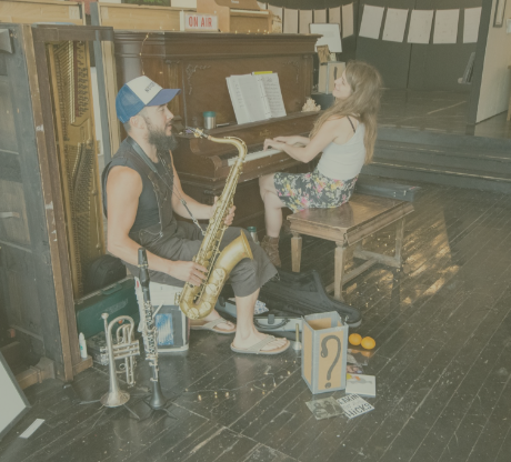 Person Playing Saxaphone and Piano