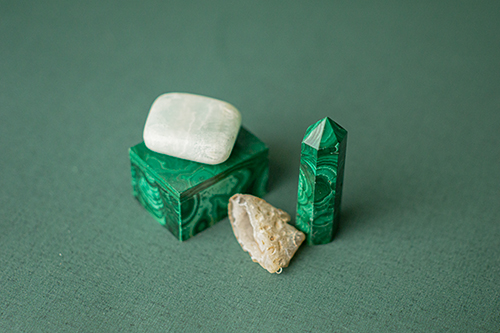malachite, geode, and aqua jade in a group sitting on a green cloth.
