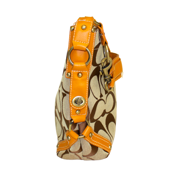 Side view of Cassie, brown Coach monogram pattern and orange leather straps, featuring gold hardware accents.