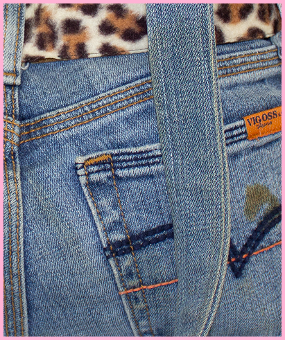 Up close shot of Jenine showing an orange Vigoss Jeans USA tag, and denim texture.