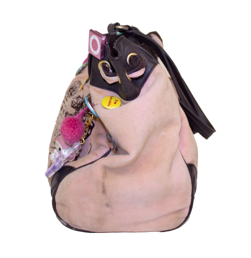 Second side view of Juicy Couture handbag that showcases pink velveteen texture.