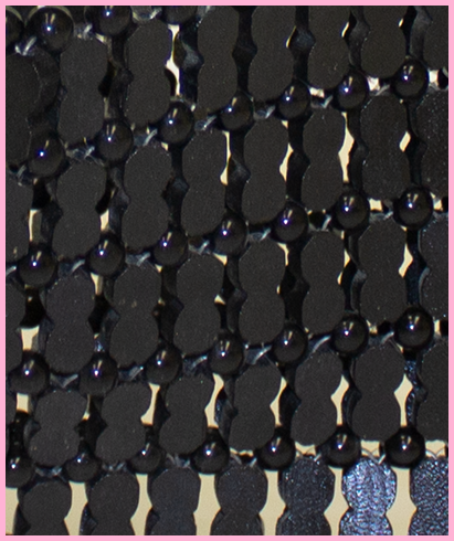 Detail shot showing black wooden beads strung together.