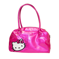 A hand holds a shiny hot pink Hello Kitty handbag with a bow, showcasing a playful and stylish accessory.