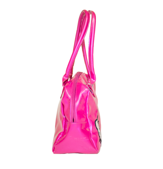 A hand holds a shiny hot pink Hello Kitty handbag with a bow, showcasing a playful and stylish accessory.