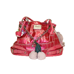 A shiny pink handbag with chain straps, pom-pom accents, and an alligator textured pattern, featuring a prominent D&G logo on the front.