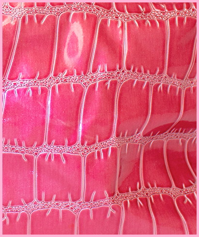 Back view of shiny pink handbag with chain straps, showing a pink zipper pocket.