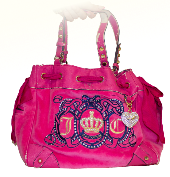 A large hot pink juicy couture purse with bedazzled keychains and blue/gold embroidery on the front, featuring a crown and the letters J and C.