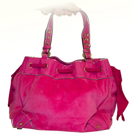 A large hot pink juicy couture purse with bedazzled keychains and blue/gold embroidery on the front, featuring a crown and the letters J and C.