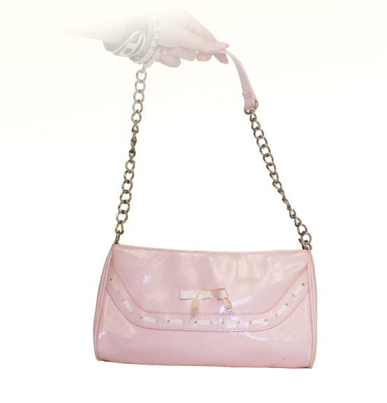 A hand holds a shiny pink clutch purse with a silver chain strap and laced bow detail on the front.
