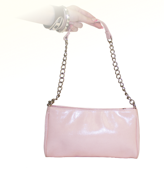 A hand holds a shiny pink clutch purse with a silver chain strap and laced bow detail on the front.
