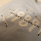 Angled view of light blue sweatshirt that reads 1989 Taylor's Version surrounded by seagulls