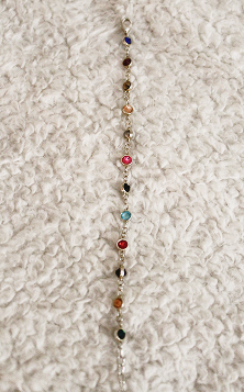 Bracelet with multicolored gems representing different Taylor Swift Albums.