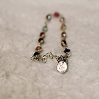 Bracelet with multicolored gems representing different Taylor Swift Albums.