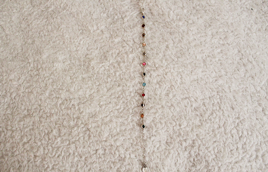 Bracelet with multicolored gems representing different Taylor Swift Albums.