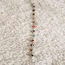 Bracelet with multicolored gems representing different Taylor Swift Albums.