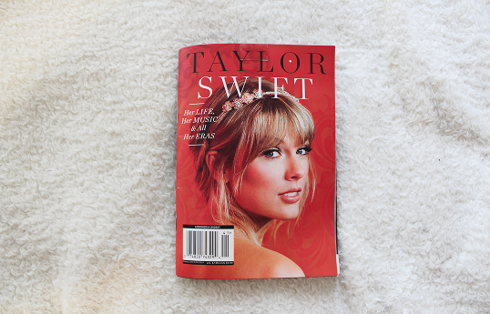 A small magazine cover with Taylor Swift's face with a title that reads Her life, her music, & and all her eras.
