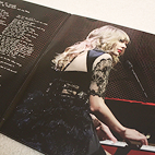 Inside spread of Red (Taylor's Version) vinyl that showcases Taylor Swift playing on the piano and lyrics to All too Well (Ten Minute Version).