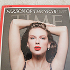 Close-up view of the front cover of Time Magazine December 2023 issue featuring a photo of Taylor Swift.