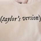 Close-up view of a light pink sweathirt that reads (Taylor's Version).