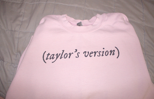 Light pink sweatshirt that reads (Taylor's Version).