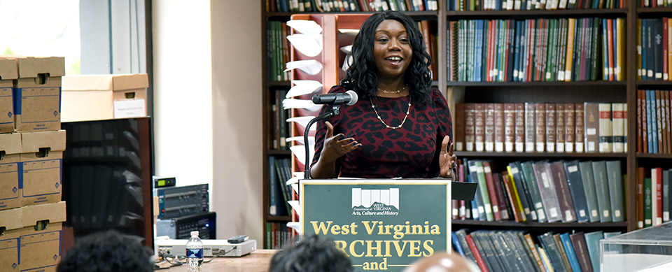 Person speaking at library event.