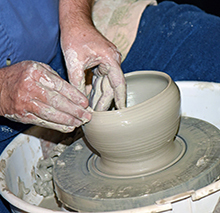 Person making pottery.